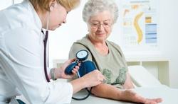 doctor measuring woman's blood presure