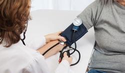 doctor measures blood pressure