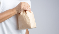 man holding paper bag